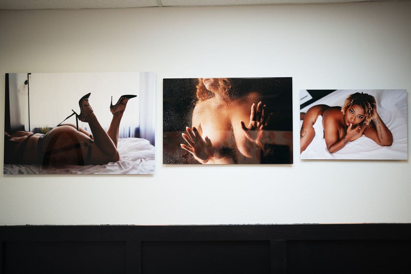Three framed boudoir prints on a gallery wall